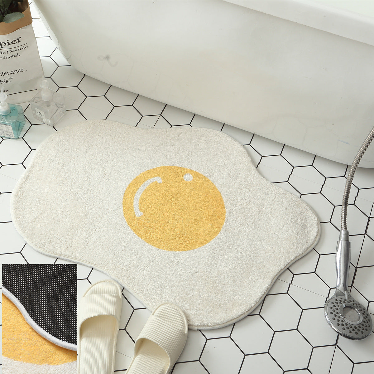 Funny egg doormat absorbing water in a bathroom setting.