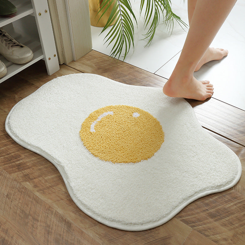 Cute egg floor mat with plush texture on wooden bathroom floor