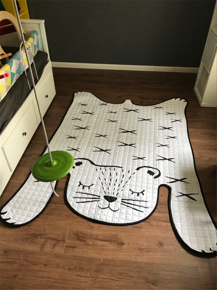 Bird’s-eye view of kids play mat with animal design in bedroom