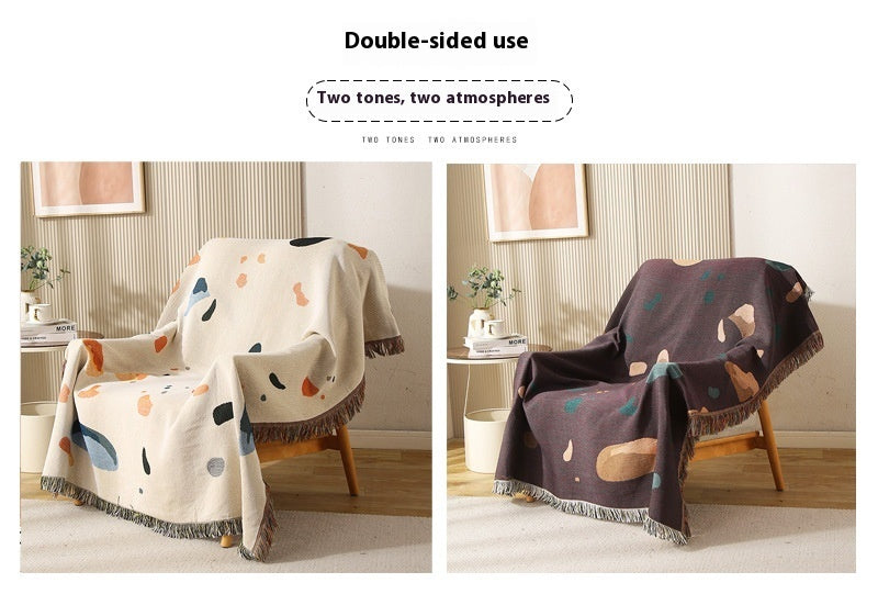 Modern shell-pattern throw blanket displayed on sofa as a decorative throw blanket