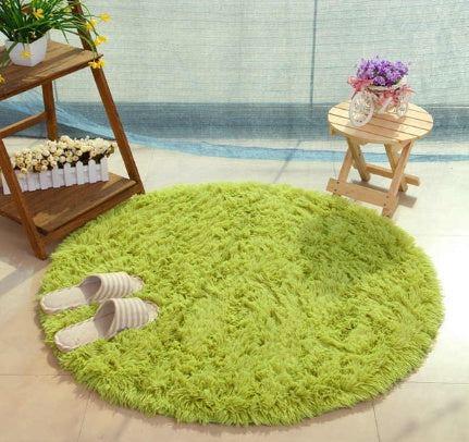 Green round soft rug placed in room interior