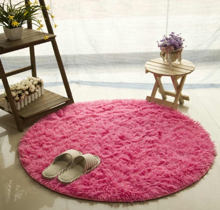 Pink round plush faux fur rug with chair setup