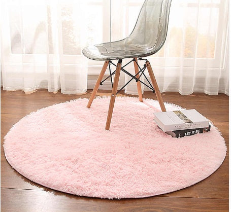 Pink round plush faux fur rug with chair setup
