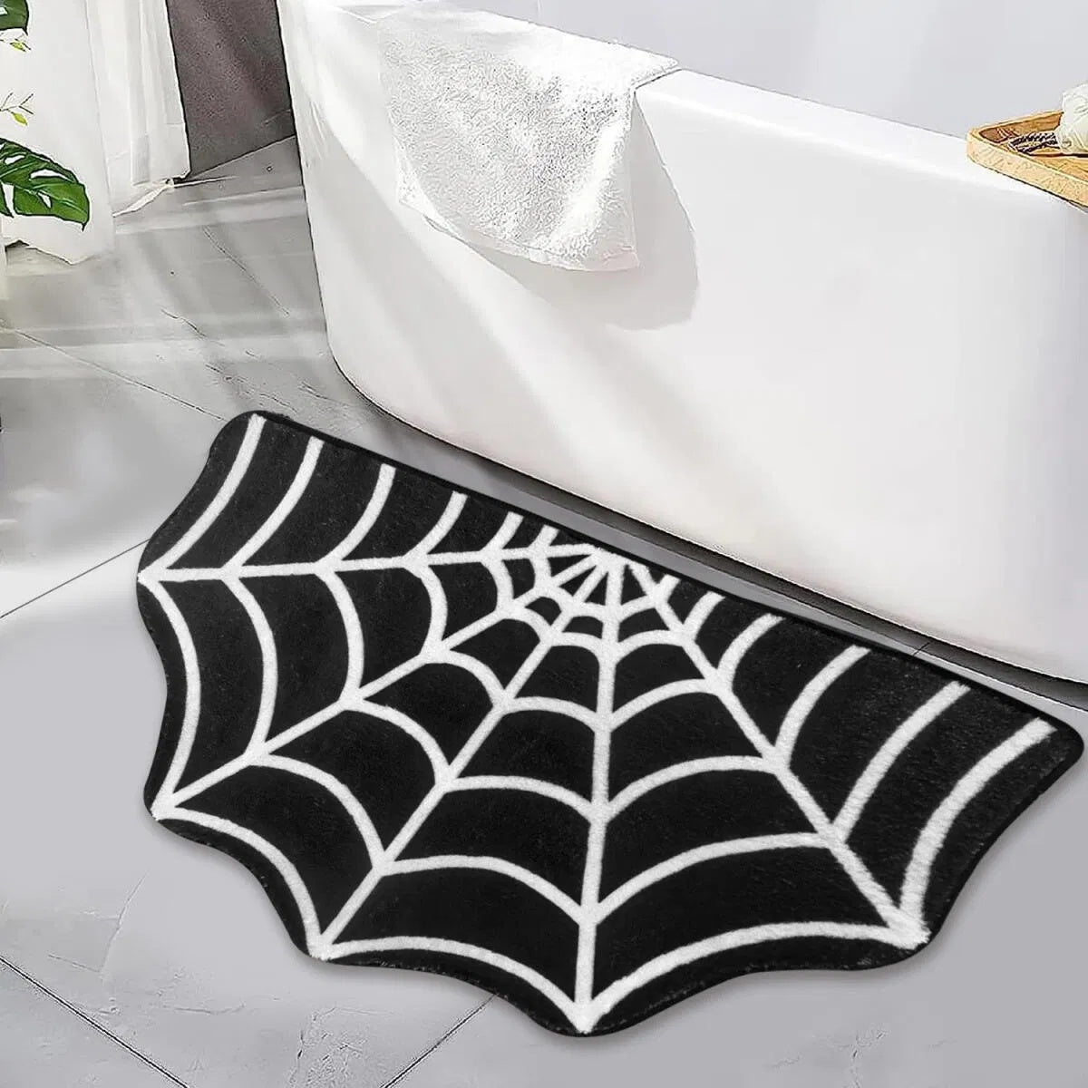 Spider web bath mat placed in modern bathroom next to tub