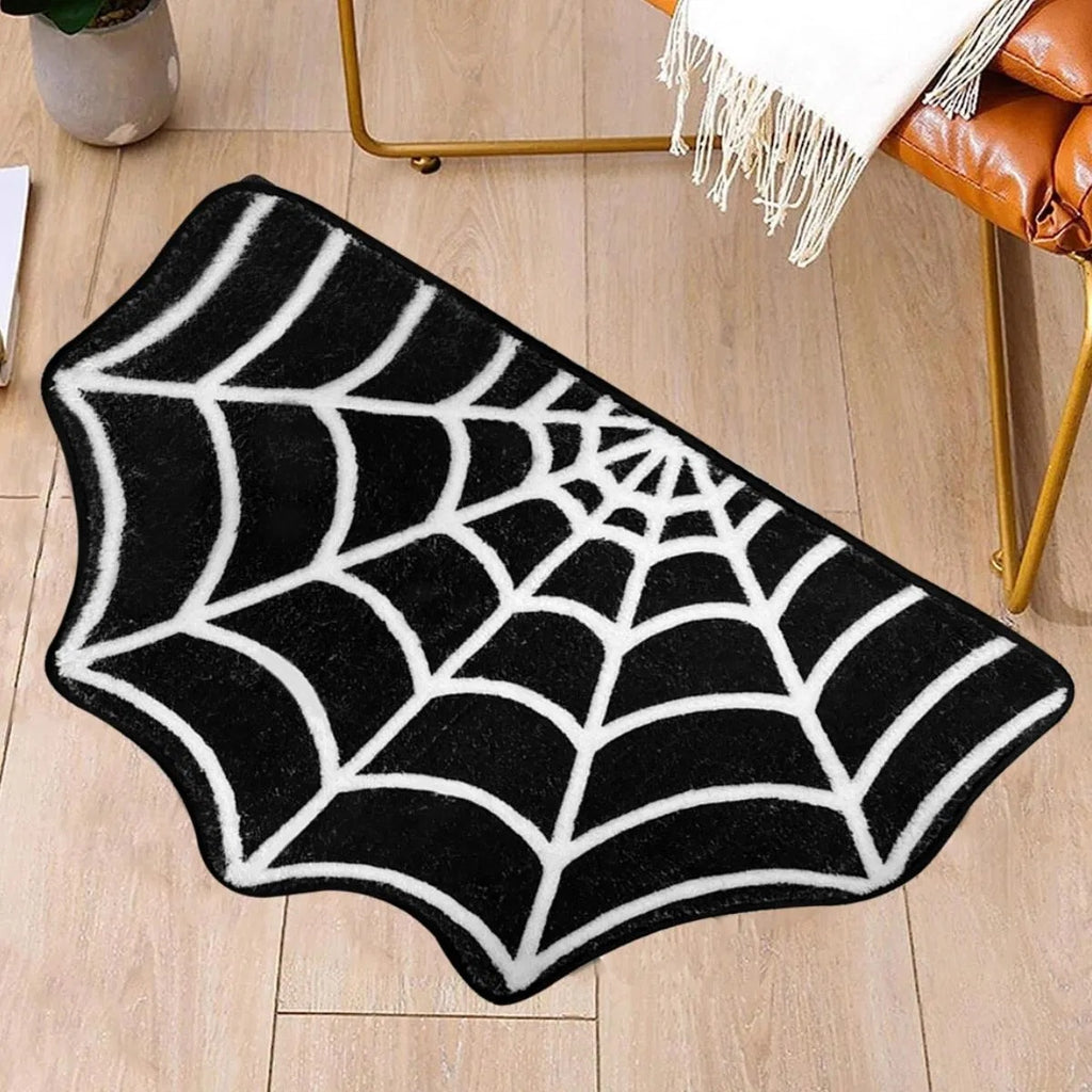 Black and white spider web mat on wooden floor