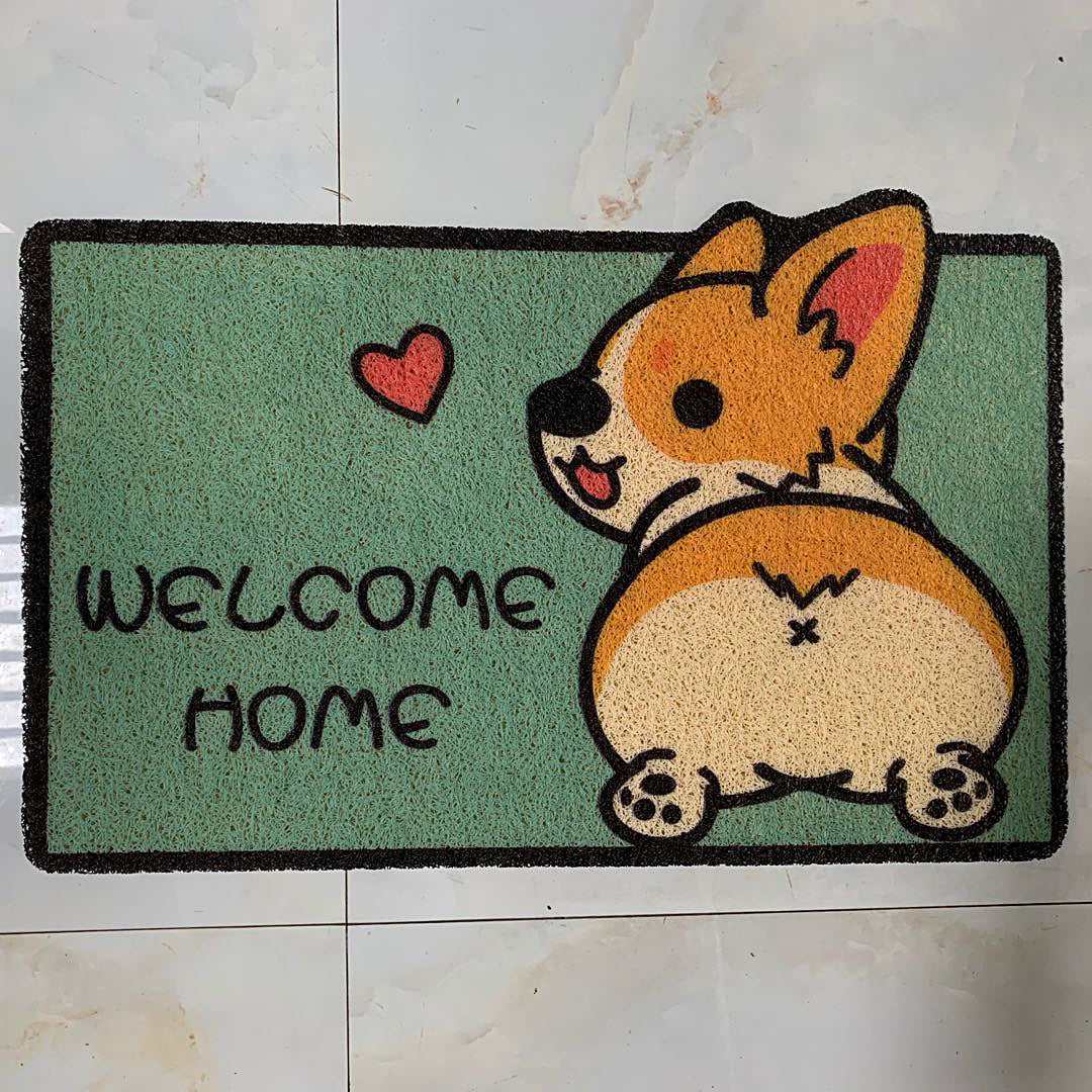Doormat with a cartoon dog and 'Welcome Home' text on a green background